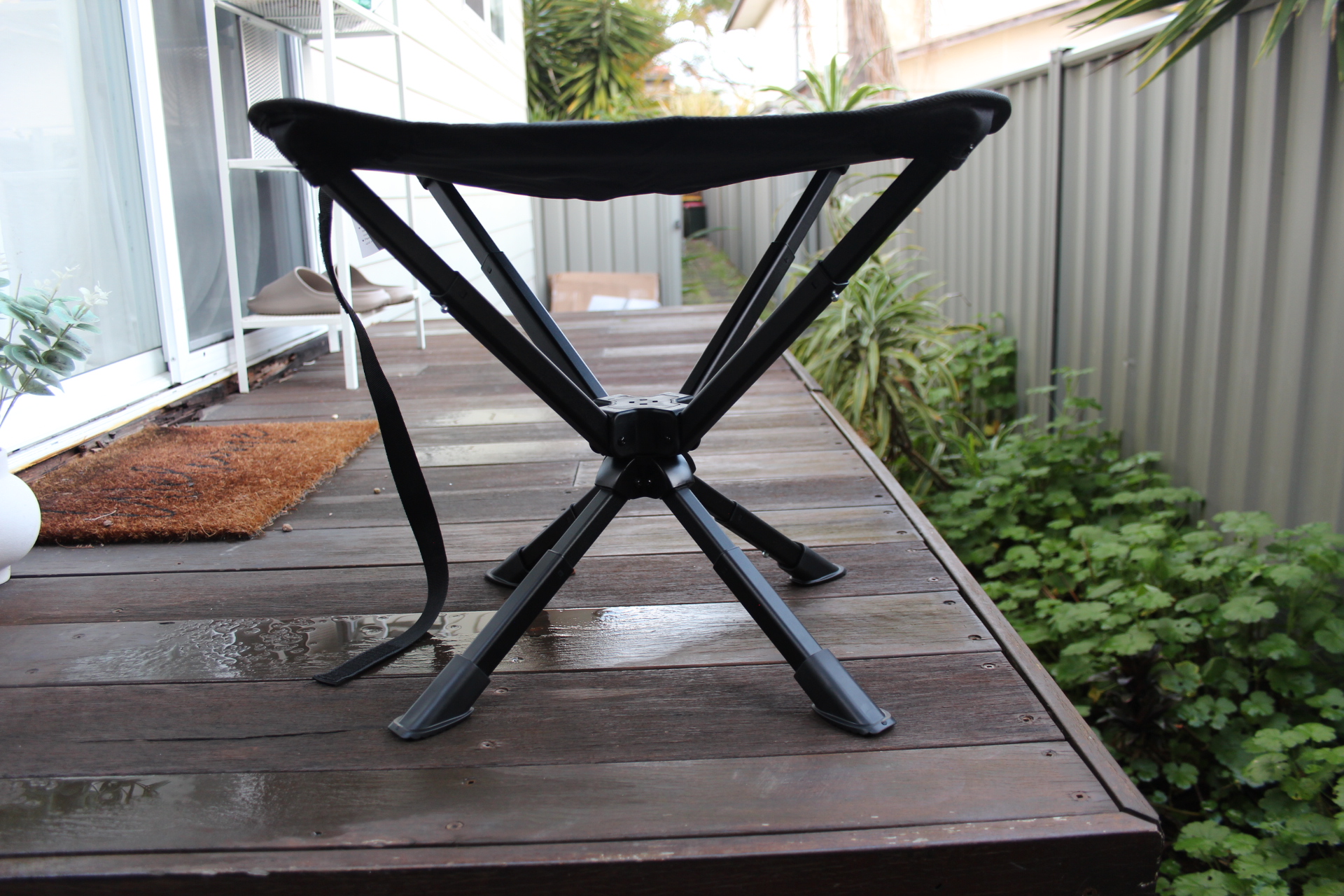 Restup set up on a wet timber deck, showing its four-legged X-frame