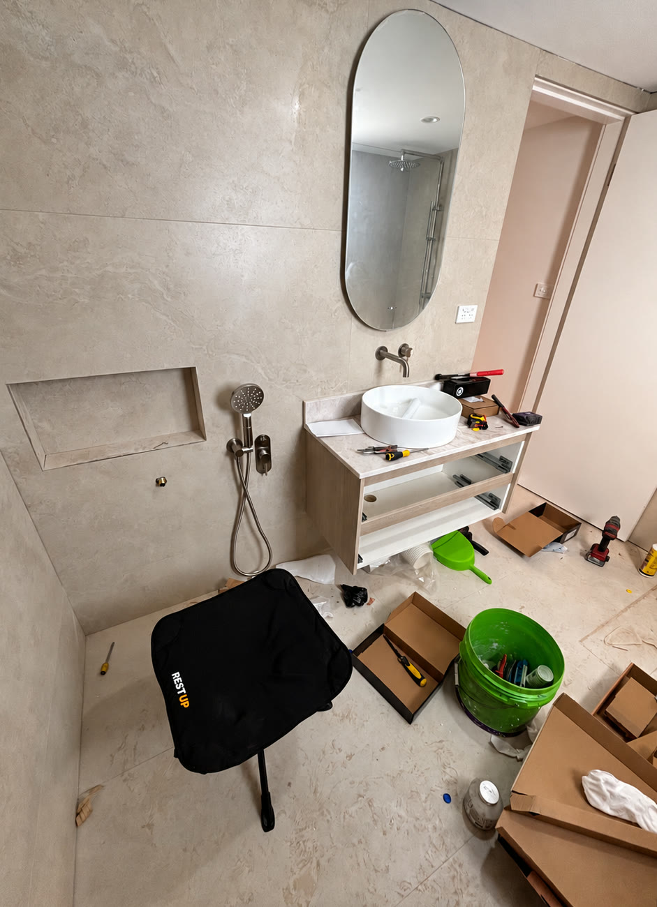 Customer photo: a Restup seat on the job during a bathroom renovation, surrounded by tools